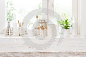 Wooden table over blurred kitchen window sill with food ingredients