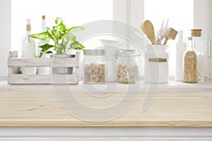 Wooden table over blurred kitchen window sill for product display