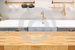 Wooden table over  kitchen blurred counter background. Interior for mock up design and product display