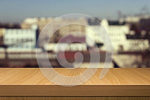 Wooden table over outdoor city blur background