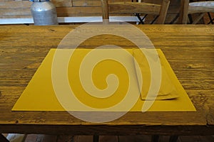 Wooden table with paper placemat