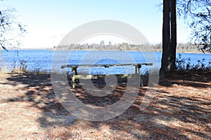 Wooden table in park near the water