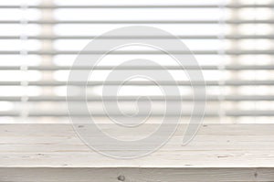 Wooden table from planks on window with venetian blinds background