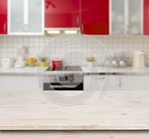 Wooden table on red modern kitchen bench interior background