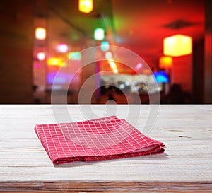 Wooden table with red napkin. Cafe background