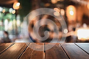 Wooden table on a restaurant blurred background is an abstract background