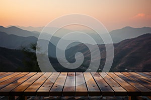 A wooden table set against a blurred, picturesque sunset mountain scene