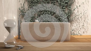 Wooden table or shelf with crystal hourglass measuring the passing time over minimalist bathroom with bathtub, garden with ivy,