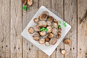 Wooden table with Shiitake mushrooms, selective focus