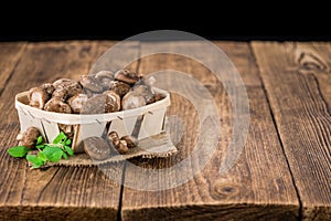 Wooden table with Shiitake mushrooms, selective focus