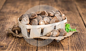 Wooden table with Shiitake mushrooms, selective focus