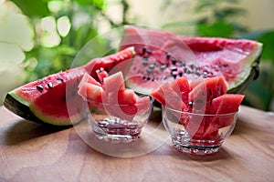 On a wooden table slices of ripe watermelon