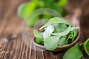 Wooden table with Stevia leaves (selective focus)