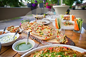 wooden table on the street in a cafe with food, Outdoor terrace concept of a buffet table, catering.