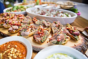 wooden table on the street in a cafe with food, Outdoor terrace concept of a buffet table, catering.