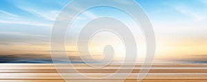 Wooden table top with blue sky, cloud and sunlight background.