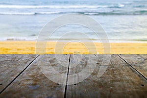 Wooden table top on blur beach background. Can be used for display