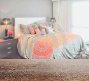 Wooden table top with blur of bedroom in lively style