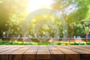 Wooden table top on blur green park background - can be used for display or montage your products