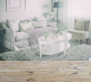 Wooden table top with blur of living room interior