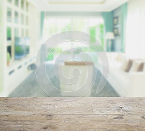 Wooden table top with blur of modern style living room interior