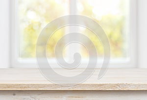 Wooden table top on blurred glass window wall building background