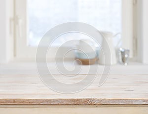 Wooden table top on blurred kitchen window background