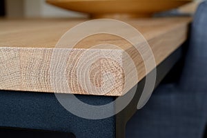Wooden table top corner closeup.