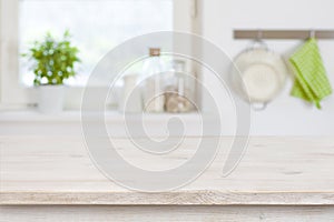Wooden table top in front of blurred kitchen interior background