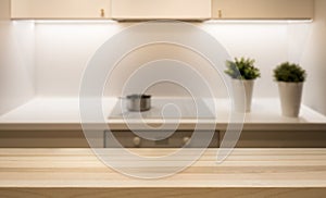 Wooden table top on kitchen island in modern simple home interior.