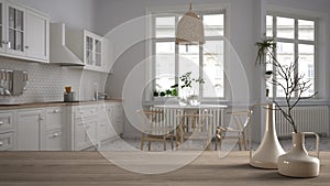 Wooden table top or shelf with minimalistic modern vases over blurred retro white kitchen with table and chairs, herringbone