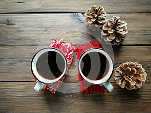 On the wooden table are two cups of Americano and three cones. winter coziness.