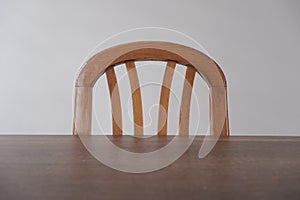 A wooden table and upper side of wooden vintage and retro style chairs