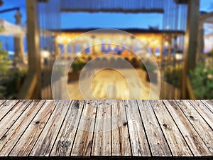 wooden table with a view of blurred beverages bar backdrop, empty table to showcase your product, against the background of a