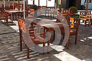 Wooden tables and chaires on terrace photo
