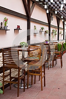 Wooden tables and chaires on terrace photo