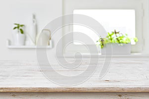 Wooden tabletop with copy space over blur kitchen window background