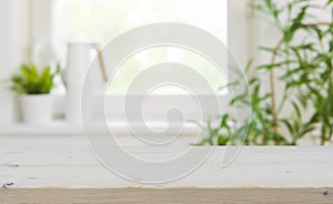 Wooden tabletop with copy space over blurred kitchen window background photo