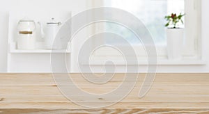 Wooden tabletop in front of blurred kitchen window, shelves background