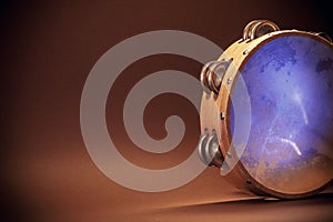 Wooden Tambourine on Brown Background