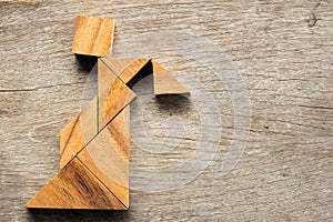 Wooden tangram puzzle in woman held the lattern shape photo