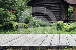 Wooden terrace or path with green lawn and trees at yard or garden. Garden landscape design