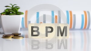 Wooden Text Block of BPM with charts,coins