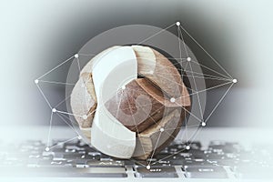 wooden texture globe with social media diagram on laptop compute