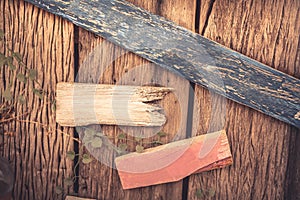 Wooden textured background as old cracked wooden fence with blank wooden directional signs with copy space
