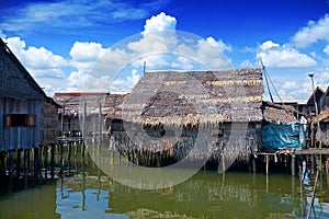 Wooden thatched roof houses on stilts