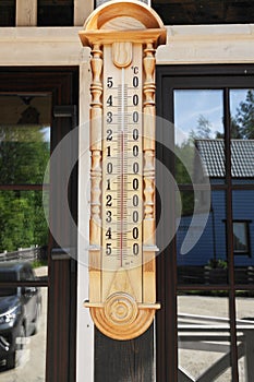 Wooden thermometer outside in summer