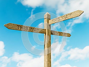 Wooden three-directional sign post with the thext This Way