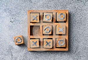 Wooden tic tac toe O X game.