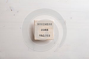 Wooden tile with a Business core value sign on it